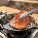 Suncrest Farms country ham biscuit pieces being cooked in a cast iron pan.