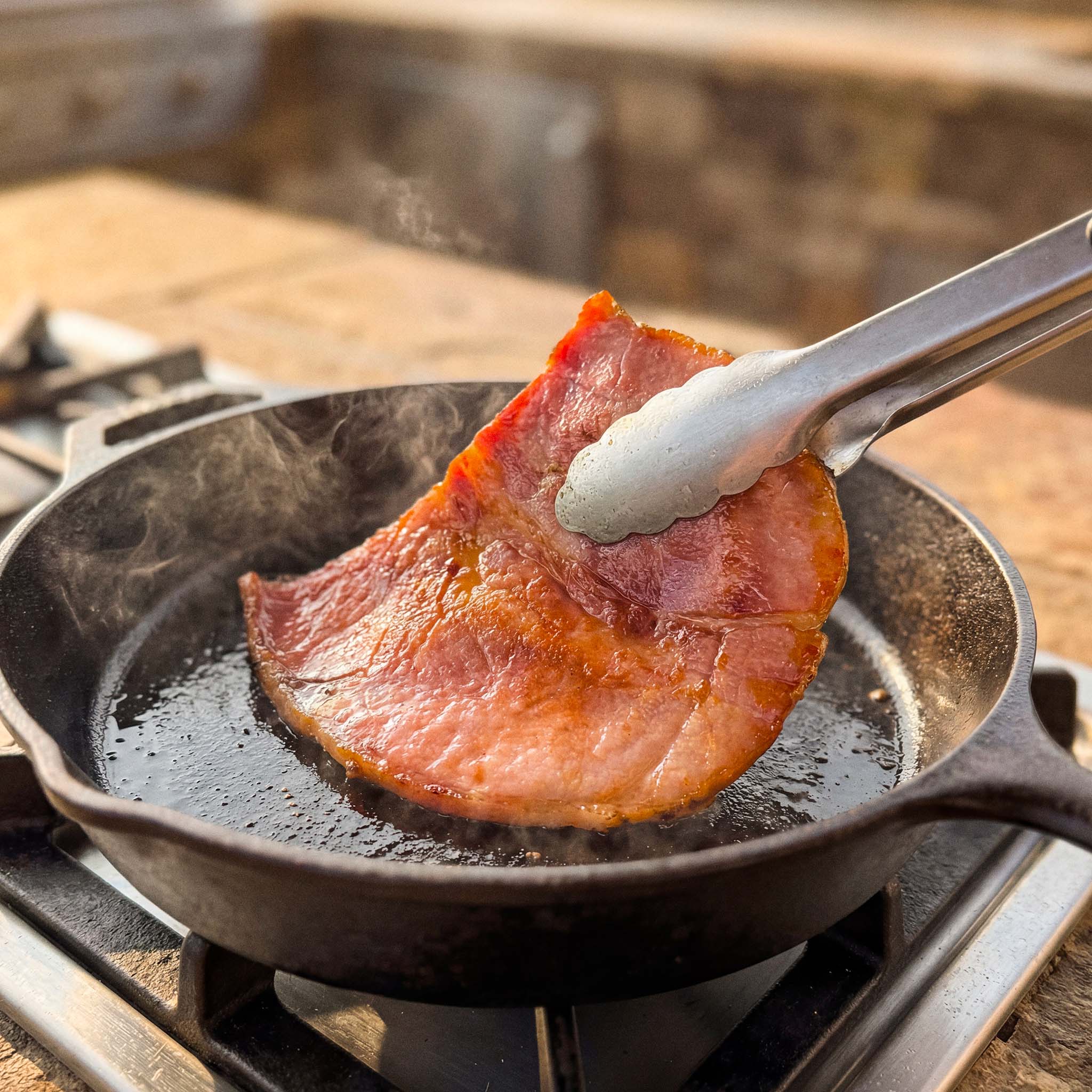 Suncrest Farms country ham biscuit pieces being cooked in a cast iron pan.