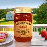 The Dutch Kettle Homemade Style Amish Strawberry Jam on a table with strawberries and toast in front of a country setting.