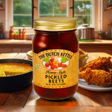 The Dutch Kettle Amish Homestyle Pickled Beets on a wooden table with fried chicken and cornbread in a southern kitchen.