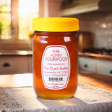 The Dutch Kettle Pure Sourwood Honey on a wooden countertop in a southern kitchen.