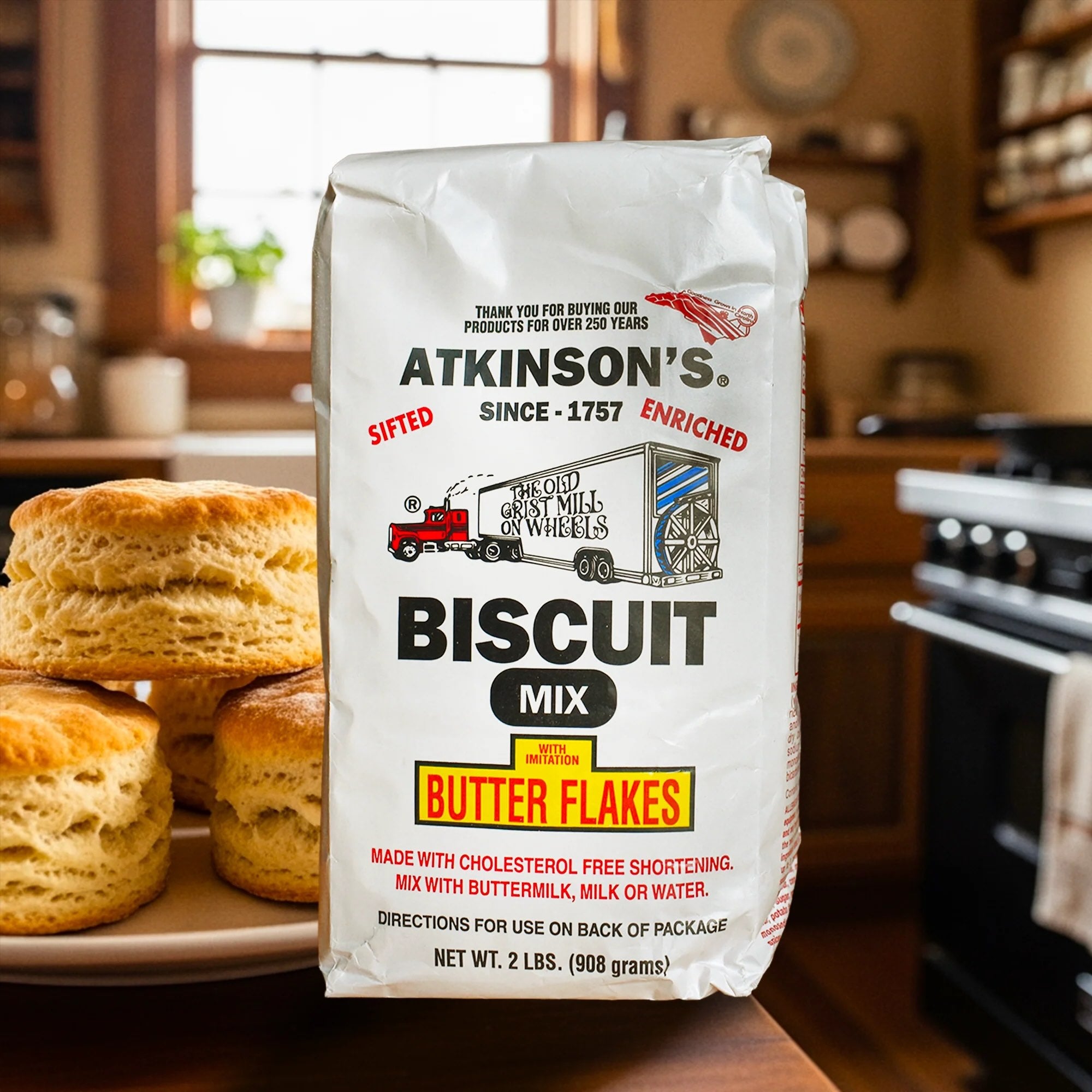 Bag of Atkinson's Biscuit Mix with butter flakes with biscuits in the background.