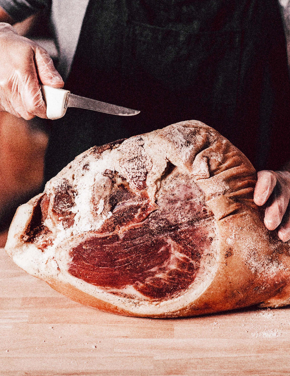 Butcher cutting Suncrest Farms whole cured country ham. 