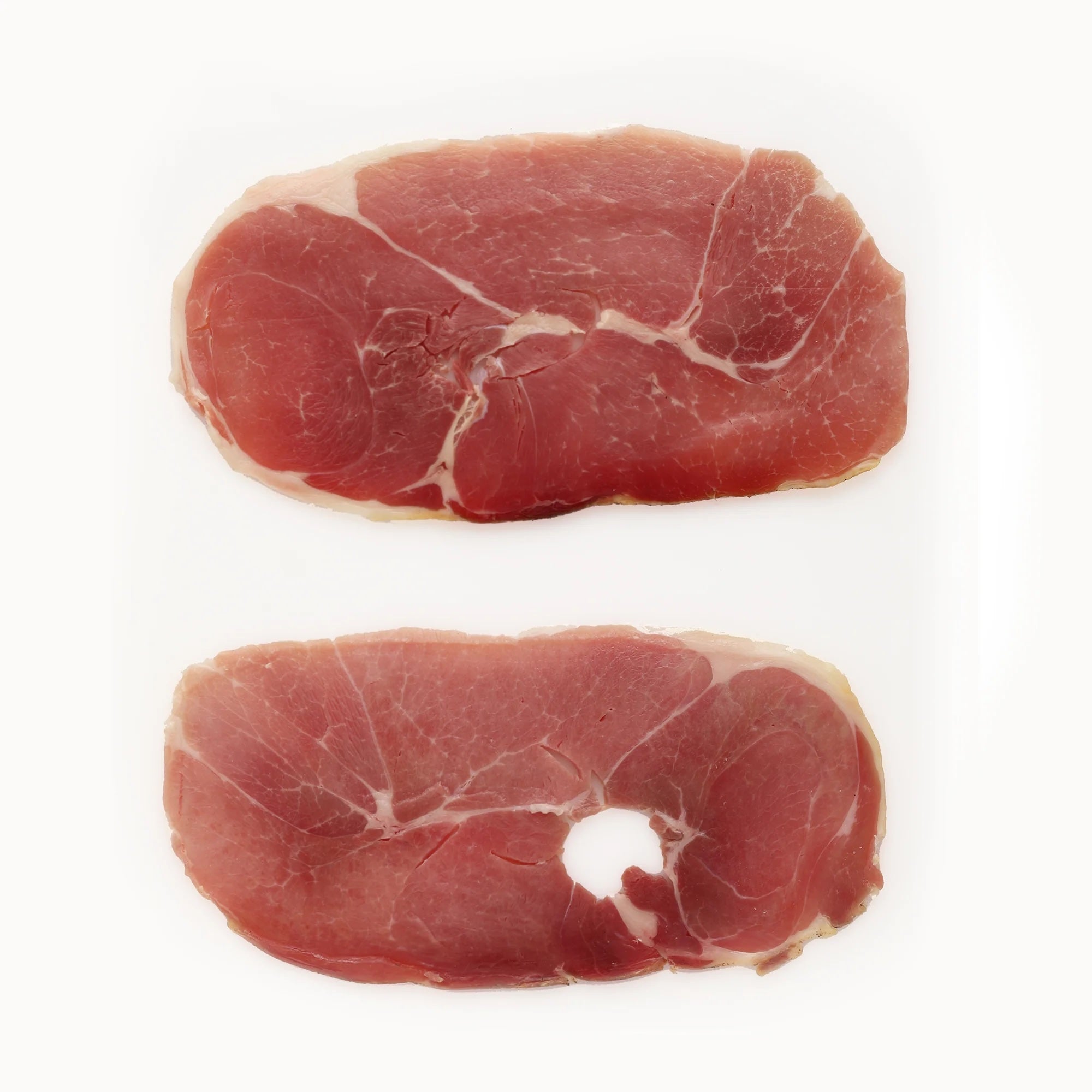 Two slices of Suncrest Farms country ham steak slices on a white background.