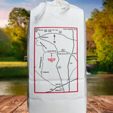 Linney Water Mill white corn grits with a map design on a wooden surface with a natural background.