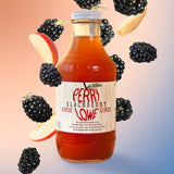 Perry Lowe orchards blackberry apple cider jar on a pink and blue gradient background with blackberries surrounding jar.