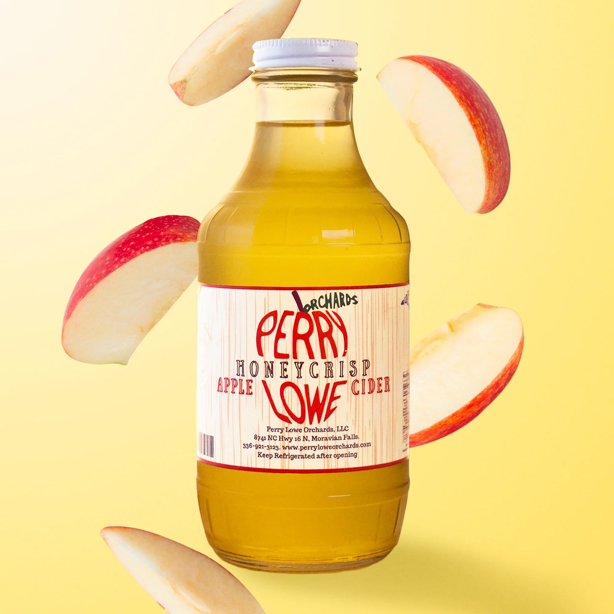 Perry Lowe Orchards Honeycrisp apple cider jar on a yellow gradient background with apple slices surrounding jar.